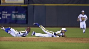 Courtney Hawkins hit aline drive leadoff single between Moody infielders Juan Farias (L) and Cody Perez (R) at the Whataburger Field Monday, February 20, 2012. Hawkins went on to score for a 1-0 Tiger lead.